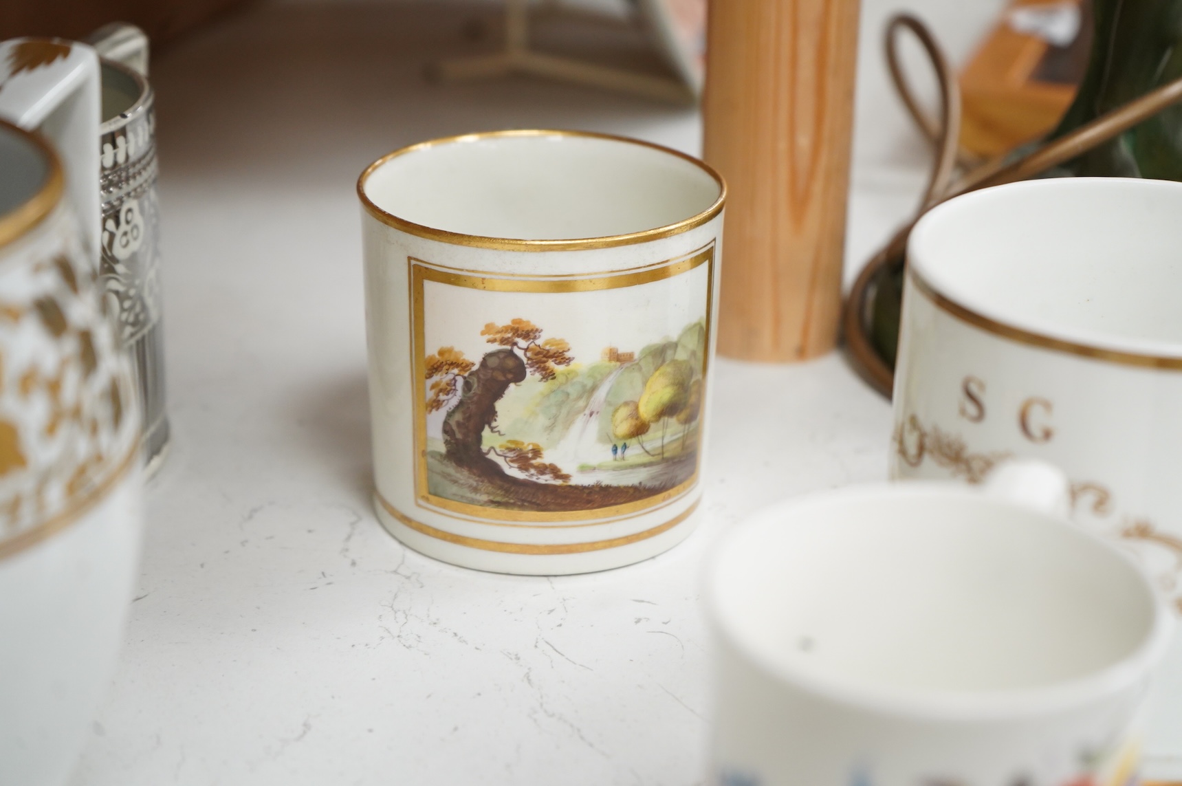 A pair of early 19th century English porcelain large mugs with gilt bands and five other early 19th century porcelain or pearlware mugs, one inscribed SG, Forget Me Not, largest each 14cm high